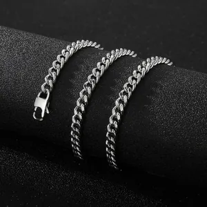 Close-up detail of a silver stainless steel Cuban chain necklace with lobster clasp