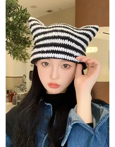 Close-up of a stylish handmade crochet striped knit hat featuring cute cat ear design