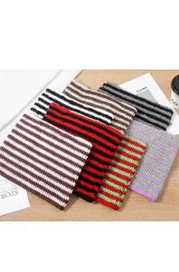 Selection of handmade crochet striped beanie hats in various contrasting colors