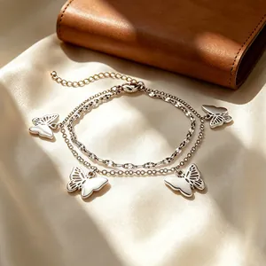 Double-layered silver stainless steel bracelet with cutout butterfly charms.