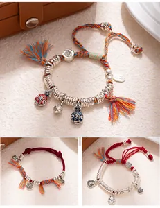 Detailed view of handmade Chinese-style braided bracelets with silver charms and tassels