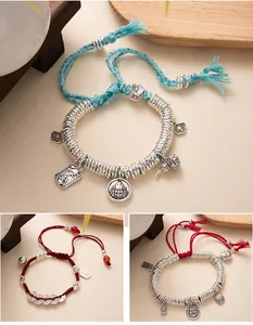 Close-up of handmade New Chinese style braided bracelets with silver charms and beads