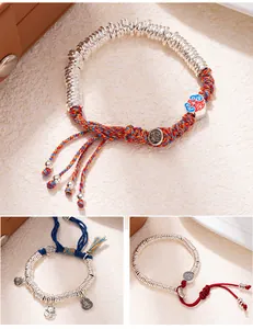 Macro shot of three traditional Chinese style silver beaded bracelets with braided cords
