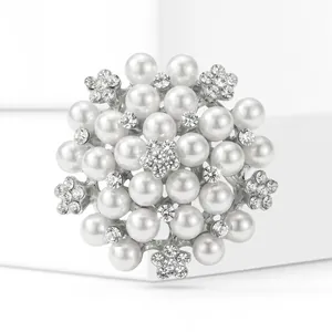 Gros plan d'une broche circulaire avec perles blanches et cristaux en forme de fleur