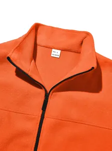 Detailed close-up view of orange polar fleece outdoor jacket collar with zipper and size tag