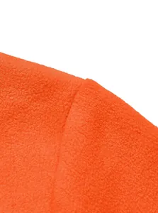Close-up macro shot showing the soft orange fleece fabric texture of the outdoor jacket