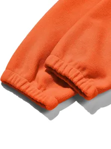 Close-up detail of orange fleece jacket elastic cuffs showing high quality texture