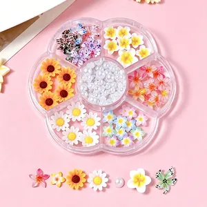 Detailed view of mixed 3D resin flower and pearl nail art accessories in a storage box.