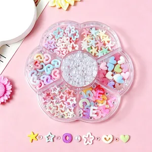 Detailed view of 7-compartment flower-shaped box filled with pastel nail art charms and pearls