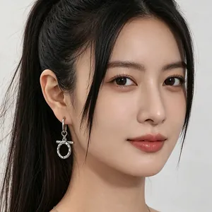 Vintage titanium steel OT buckle earrings with a wrinkled texture shown on an Asian model.