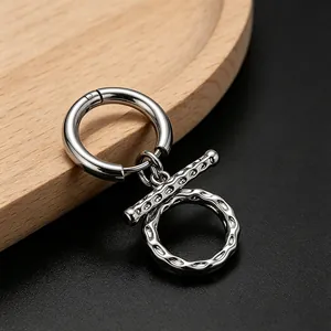 Close-up of titanium steel earring with wrinkled texture and OT buckle design.