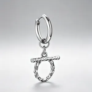 Detailed view of titanium steel hoop earring with a textured silver OT toggle pendant