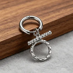Detailed close-up of a silver titanium steel OT buckle earring with wrinkled hammered texture