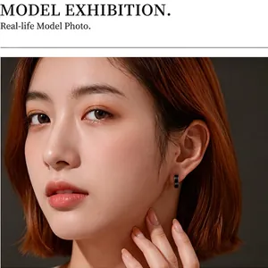 Minimalist black enamel stainless steel hoop earrings for men and women shown on a model