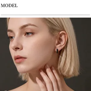 Professional model wearing minimalist black enamel stainless steel hoop earring