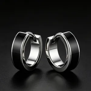 Close-up of sleek minimalist black epoxy stainless steel hoop earrings for men
