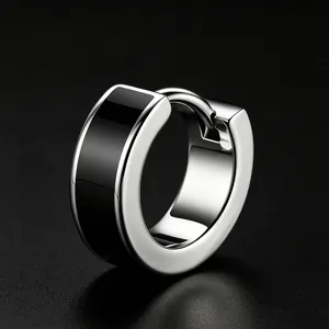 Macro view of minimalist stainless steel hoop earring with black enamel inlay