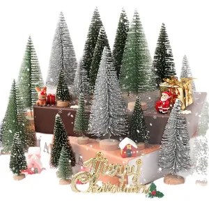 Miniature snow-dusted Christmas trees and festive ornaments set for holiday desktop decoration