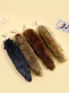 Macro view of fluffy fur tail keychains in four natural gradient colors