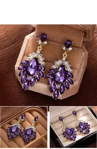 Detailed view of vintage purple rhinestone tassel earrings in a velvet jewelry box