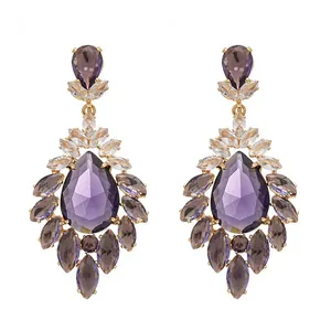 Elegant vintage gold-tone chandelier earrings featuring multi-faceted teardrop purple crystals