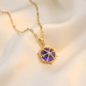 Elegant gold necklace with blue gemstone pendant in niche floral cage design