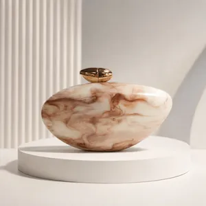 Close-up of elegant acrylic evening clutch with marble pattern and gold metallic clasp