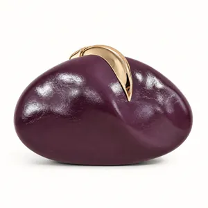 Detail shot of a purple PU pebble clutch featuring an organic shape and gold clasp.