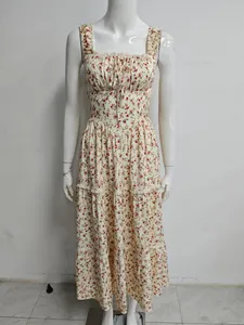 Detailed view of a French style floral tiered maxi dress featuring ruffle straps and tie-front