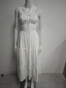 Close-up front view of a white tiered midi dress featuring delicate ruffle lace straps