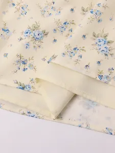 Close-up detail showing the neat hemline and floral fabric of this French style dress