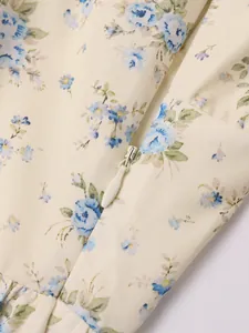 Close-up detail of the invisible zipper on a French floral print summer strap dress