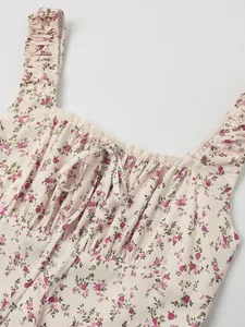 Detail shot of a French floral dress featuring square neck, ruffle straps and lace trim.