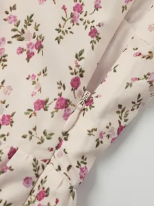 Detailed view of the invisible back zipper on this French style floral print summer dress.