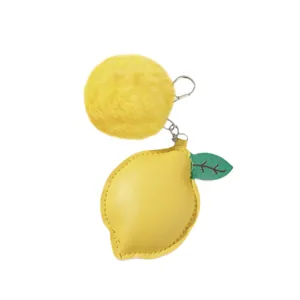 Lemon-shaped PU leather keychain with a yellow faux fur pom-pom ball accessory