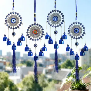 Blue evil eye wind chimes with bells and tassels for home wall or door decoration.