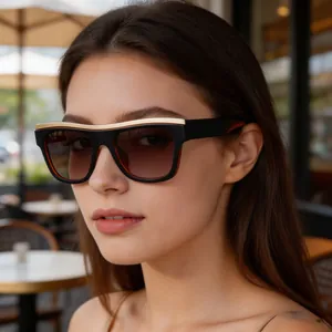 Close-up of trendy cat-eye sunglasses with a gold metallic brow bar on a female model