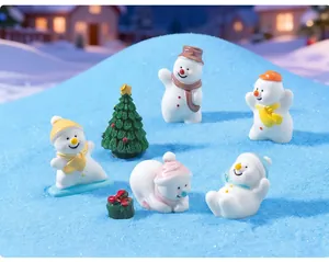 Macro view of miniature resin Christmas snowmen and tree ornaments for winter DIY décor