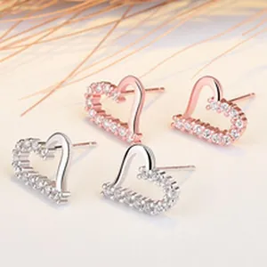 Detail view of s925 sterling silver heart earrings with pave-set shimmering stones.