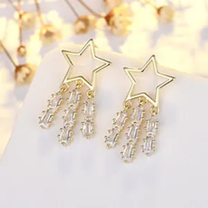 Detailed close-up of French vintage gold-plated star earrings with crystal tassels
