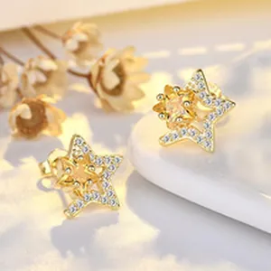 Close-up of gold-plated S925 silver star earrings featuring full pave cubic zirconia detail.