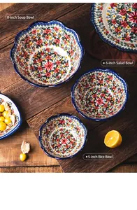 Detail of floral ceramic bowls on a rustic wooden table with decorative lemon.