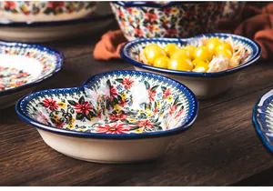 Detailed close-up of a heart-shaped ceramic bowl featuring exotic daisy floral patterns