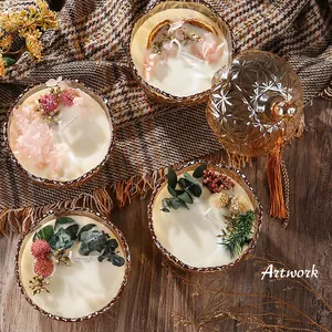 Elegant scented candle set with dried flowers in amber embossed glass jars.