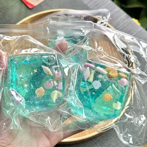 Ocean-themed sea shell squishy ice cube toys in clear plastic bags shown in hand.