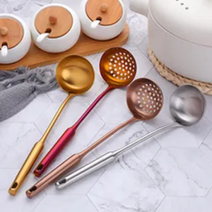 Four colorful large stainless steel serving and slotted spoons for hotel buffet
