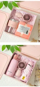Pink souvenir gift set with handheld fan, water bottle, and umbrella