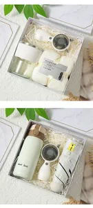 Elegant gift set box with handheld fan, cup, and umbrella in marble packaging.