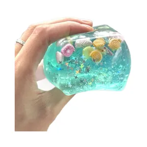 Close-up detail of stress relief ice cube squishy toy with ocean shell charms inside