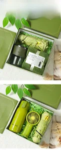Green corporate gift set featuring umbrella, thermos bottle, and portable fan details.